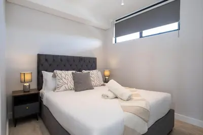 a bedroom with a large white bed and a window at Burmeister 302 - Beach Front Views with Onsite Parking in Cape Town