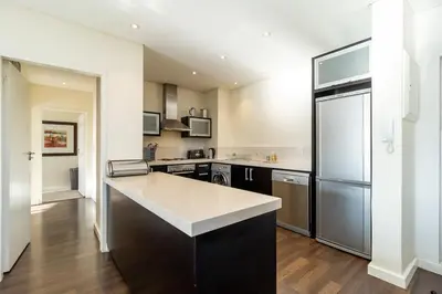 a large kitchen with a large island in the middle at Skyline Serenity - Knightsbridge in Cape Town