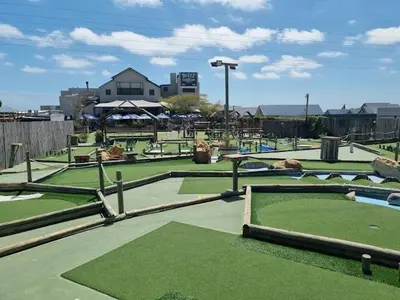 a park with a golf course with green grass at Budapest Boutique Hotel in Edgemead