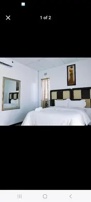 a bedroom with a large bed with white sheets at 27 on Milton in Cape Town