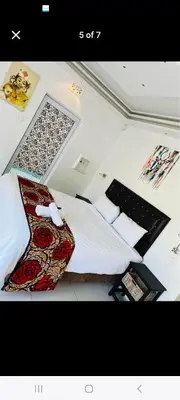 a bedroom with a bed and a laptop on top of it at 27 on Milton in Cape Town
