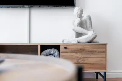 a statue of a man sitting on top of a dresser at Odeon Towers 1007 by Host Agents in Cape Town
