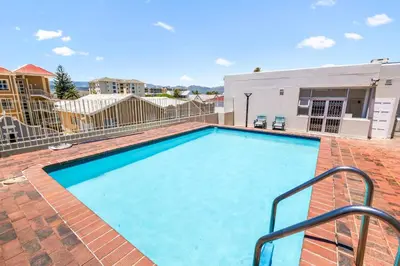 a large swimming pool in a building with a building at Odeon Towers 1007 by Host Agents in Cape Town