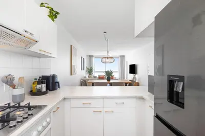 a kitchen with white cabinets and a stove top oven at Odeon Towers 1007 by Host Agents in Cape Town