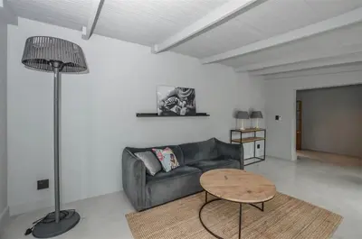 a living room with a couch and a table at 4 Bedroom Farm House in Brackenfell