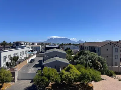 an aerial view of a city with mountains in the background at Protea house in Cape Town