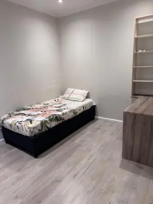 a bedroom with a bed in the corner of a room at Protea house in Cape Town