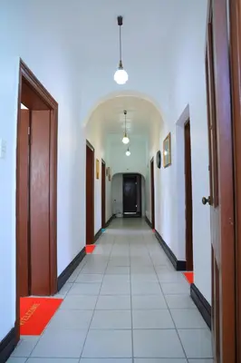 a hallway with a long corridor with two doors and a hallwayngthngthngthngth at paradise guest house in Cape Town