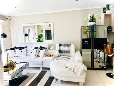 a living room with white furniture and a white couch at Luxury 2bedrooms house in Cape Town