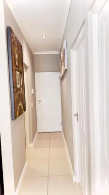 a hallway with a white door and a tile floor at Luxury 2bedrooms house in Cape Town