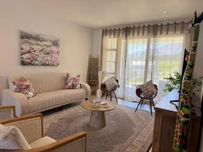 a living room with a couch and a table at Le Bourgette 28 Misty Wink in Franschhoek
