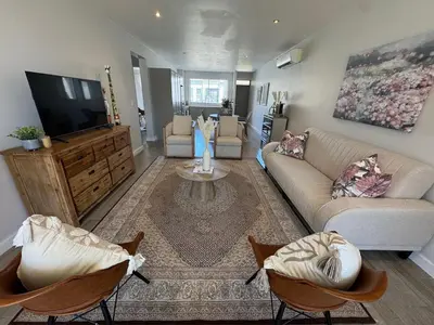 a living room with a couch and a tv at Le Bourgette 28 Misty Wink in Franschhoek