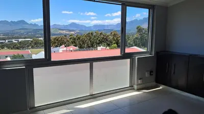 a room with two large windows with a view at Gordon's bay - Sea view apartment in Cape Town