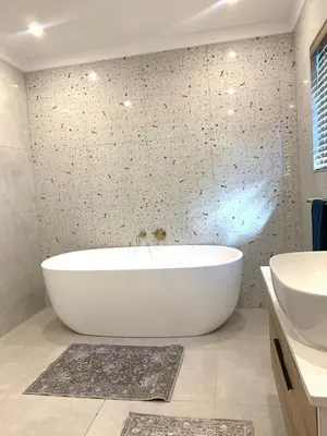 a bathroom with a white tub and a sink at Luxury 14 sleeper villa Lamsyh in Cape Town
