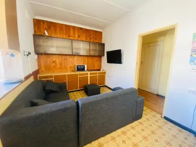 a living room with a couch and a television at Eliot TM in Cape Town