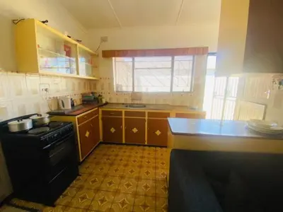 a kitchen with a sink and a stove top oven at Eliot TM in Cape Town