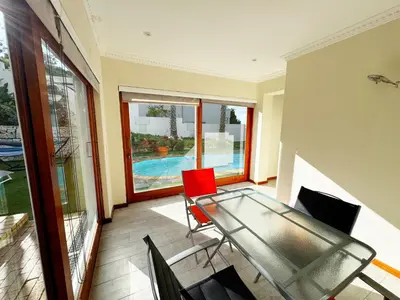 a living room with a glass table and chairs at Sea 'n Summit Hermanus in Hermanus