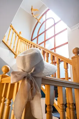 a white hat with a bow on a staircase at Sea 'n Summit Hermanus in Hermanus