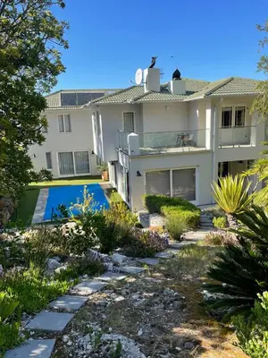 a house with a swimming pool in the yard at Sea 'n Summit Hermanus in Hermanus