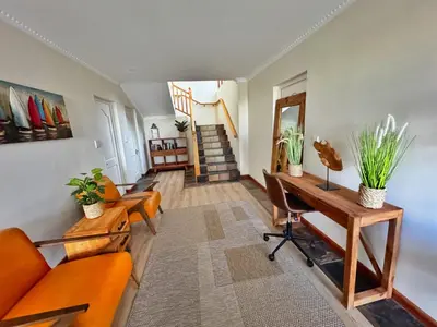 a living room with a couch and a table at Sea 'n Summit Hermanus in Hermanus