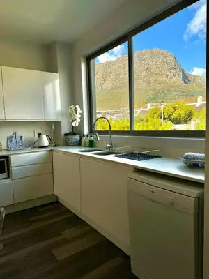 a kitchen with a sink and a large window at Le Bourgette - Close to Town With Great Views in Franschhoek