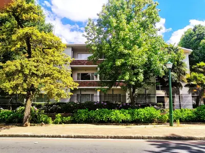 a building with trees and flowers in front of it at Sunny Mountain View in Stellenbosch