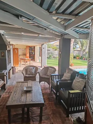 a patio with couches and a table and a pool at Johannies Home at Panorama Hospital in Cape Town