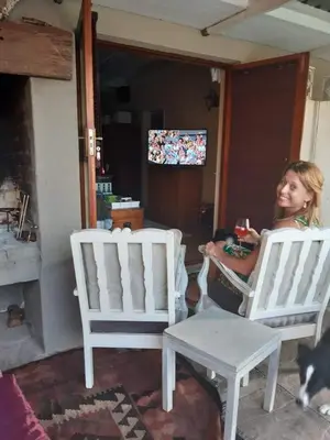 a woman sitting in rocking chairs in a room at Johannies Home at Panorama Hospital in Cape Town
