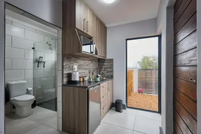 a bathroom with a toilet and a sink at Peppertree Place in Cape Town