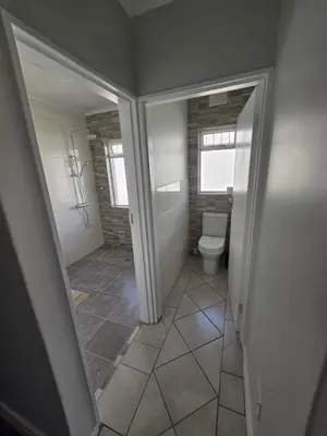 a small bathroom with a toilet and a window at Watershed Self-Catering in Wolseley
