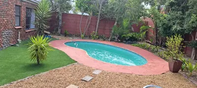 a small swimming pool in a yard with a fence at MBCholidayhouse in Cape Town