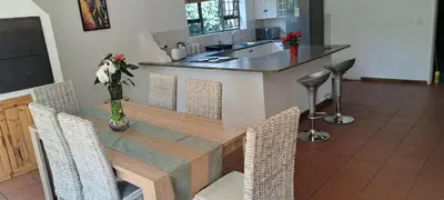 a kitchen with a table with chairs and a counter at MBCholidayhouse in Cape Town