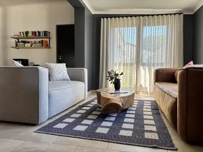 a living room with a couch and a coffee table at 2stay Apartment Protea - Cape Town Bloubergstrand in Cape Town