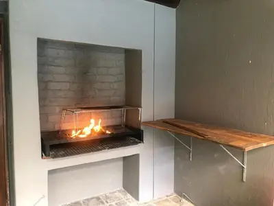 a fireplace with a fire inside of it at 82 on Second family stay in Kleinmond
