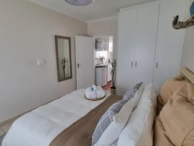 a living room with a large bed in a room at Featherbed in Hermanus