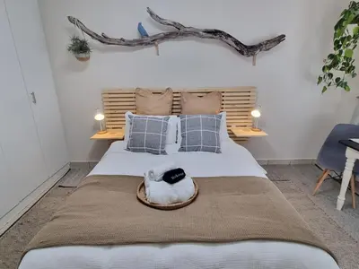 a bedroom with a bed with a hat on it at Featherbed in Hermanus