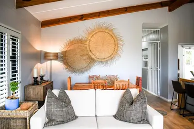 a living room with a white couch and a table at MOS- Palmiet in Kleinmond
