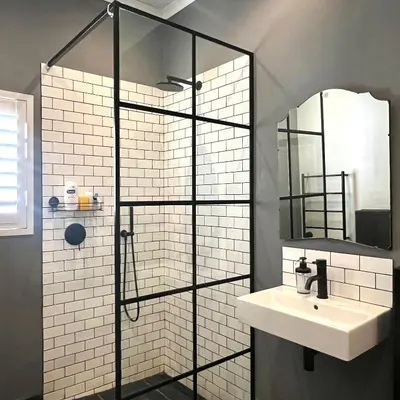 a bathroom with a shower with a sink and a mirror at Spacious Stays Residence in Paarl