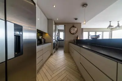 a kitchen with a counter and a clock on the wall at Apartment 206 Andringa Walk in Stellenbosch