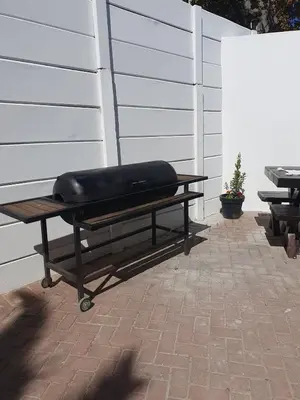 a bench with a pillow sitting on top of it at Lynwood Place in Cape Town