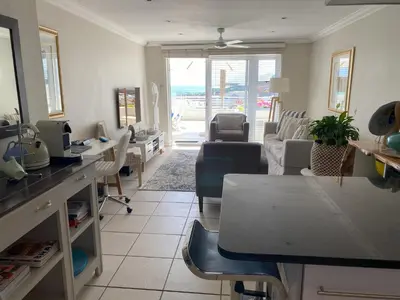 a living room with a table and chairs at Bright apartment in Cape Town