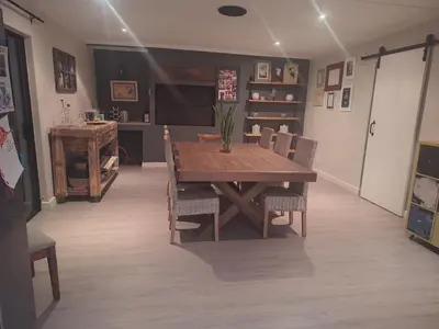 a dining room with a wooden table and chairs at KeMi Country House in Caledon