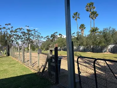 a fence with a parking meter next to a field at Hephzibah Inn Farm Cottage in Hermon