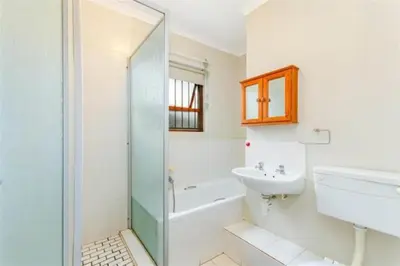 a bathroom with a sink and a toilet and a shower at Rehoboth in Cape Town