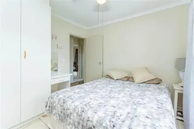 a white bedroom with a bed in a room at Rehoboth in Cape Town