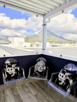 two chairs with faces on them sitting on top of an airport at Dior Maison de Reve- Private Penthouse in Stellenbosch