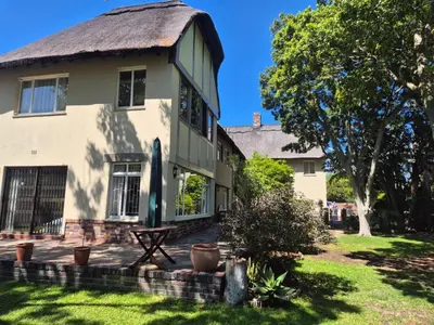 a large house with a thatched roof at Afton Safari Lodge in Cape Town