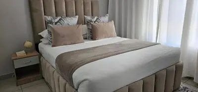 a large bed in a room with a window at 33 Langeberg Heights in Cape Town