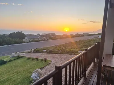 a sunset from the balcony of a house at LaMer in Bettyʼs Bay
