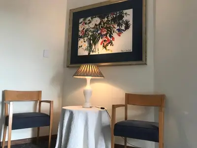 a lamp sitting on a table next to two chairs at Tolbos Grand in Somerset West